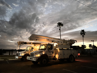 Utility workers supervised by Florida Power and Light work until sunset in Punta Gorda, Florida, on October 12, 2024. Hurricane Milton makes...