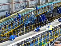 Staff produce wind turbine blades on the Shanghai Electric Wind Power (Zhangye) wind turbine blade production line in Zhangye City, Gansu Pr...