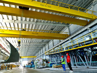 Staff produce wind turbine blades on the Shanghai Electric Wind Power (Zhangye) wind turbine blade production line in Zhangye City, Gansu Pr...