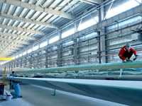 Staff produce wind turbine blades on the Shanghai Electric Wind Power (Zhangye) wind turbine blade production line in Zhangye City, Gansu Pr...