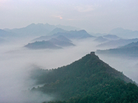 A misty morning mist hangs over the Jinshanling Great Wall in Chengde, China, on October 13, 2024. (