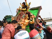 Bangladeshi Hindu devotees immerse an idol of the Hindu Goddess Durga into the river Buriganga in Dhaka, Bangladesh, on October 13, 2024. Th...