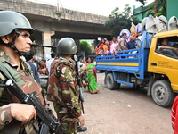 Bangladeshi Army soldiers escort Hindu devotees as they immerse an idol of the Hindu Goddess Durga into the river Buriganga in Dhaka, Bangla...