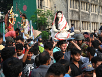 Bangladeshi Hindu devotees immerse an idol of the Hindu Goddess Durga into the river Buriganga in Dhaka, Bangladesh, on October 13, 2024. Th...