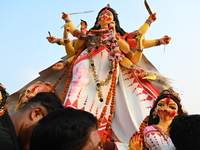 Bangladeshi Hindu devotees immerse an idol of the Hindu Goddess Durga into the river Buriganga in Dhaka, Bangladesh, on October 13, 2024. Th...