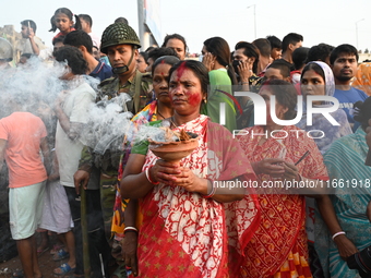 Bangladeshi Hindu devotees immerse an idol of the Hindu Goddess Durga into the river Buriganga in Dhaka, Bangladesh, on October 13, 2024. Th...