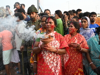 Bangladeshi Hindu devotees immerse an idol of the Hindu Goddess Durga into the river Buriganga in Dhaka, Bangladesh, on October 13, 2024. Th...