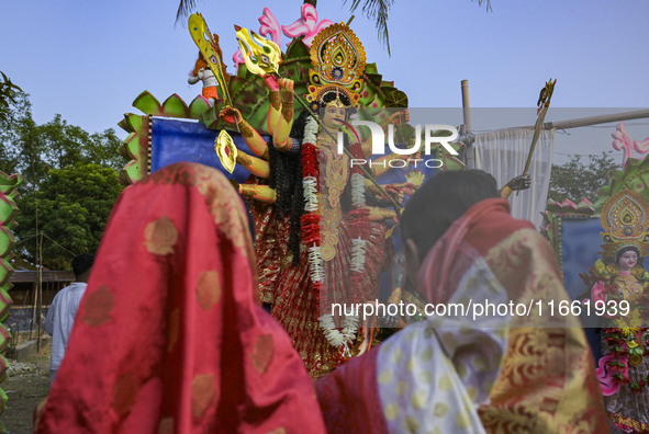 Bangladeshi Hindu devotees offer prayers to the Hindu goddess Durga idol during celebrations on the last day (Vijaya Dashami) of the Durga P...