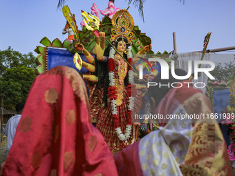 Bangladeshi Hindu devotees offer prayers to the Hindu goddess Durga idol during celebrations on the last day (Vijaya Dashami) of the Durga P...