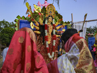 Bangladeshi Hindu devotees offer prayers to the Hindu goddess Durga idol during celebrations on the last day (Vijaya Dashami) of the Durga P...