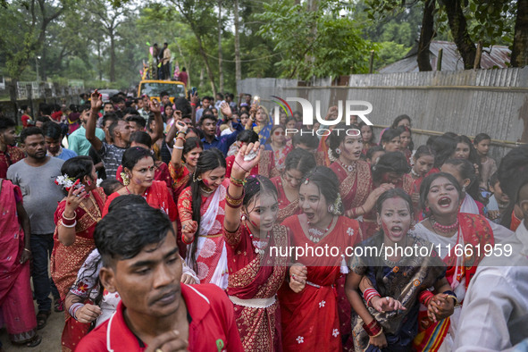 Bangladeshi Hindu devotees dance and join a rally to immerse an idol of their deity 'Durga' during the final day (Vijaya Dashami) of the Dur...