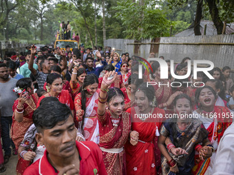 Bangladeshi Hindu devotees dance and join a rally to immerse an idol of their deity 'Durga' during the final day (Vijaya Dashami) of the Dur...