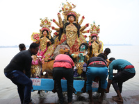 Devotees carry an idol of the Hindu goddess Durga for its immersion into the Hooghly River in Kolkata, India, on October 13, 2024. The annua...