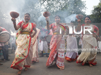 Devotees dance before immersing an idol of the Hindu goddess Durga into the Hooghly River in Kolkata, India, on October 13, 2024. The annual...