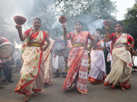 Devotees dance before immersing an idol of the Hindu goddess Durga into the Hooghly River in Kolkata, India, on October 13, 2024. The annual...