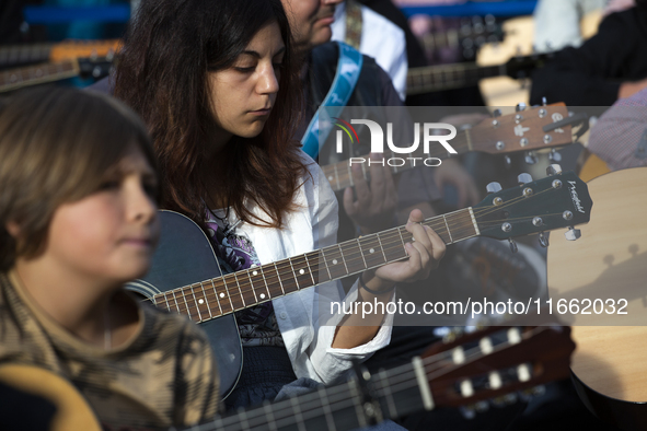 Guitar players simultaneously play the song ''Oath'' in Sofia, Bulgaria, on October 13, 2024, in memory of the legendary rock musician Kiril...