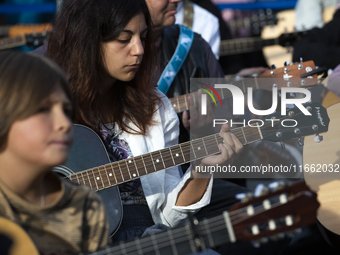 Guitar players simultaneously play the song ''Oath'' in Sofia, Bulgaria, on October 13, 2024, in memory of the legendary rock musician Kiril...