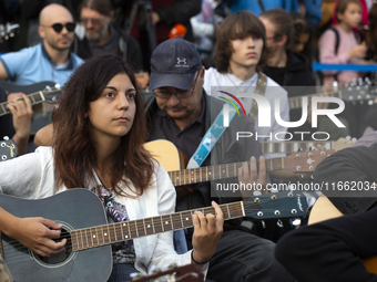 Guitar players simultaneously play the song ''Oath'' in Sofia, Bulgaria, on October 13, 2024, in memory of the legendary rock musician Kiril...