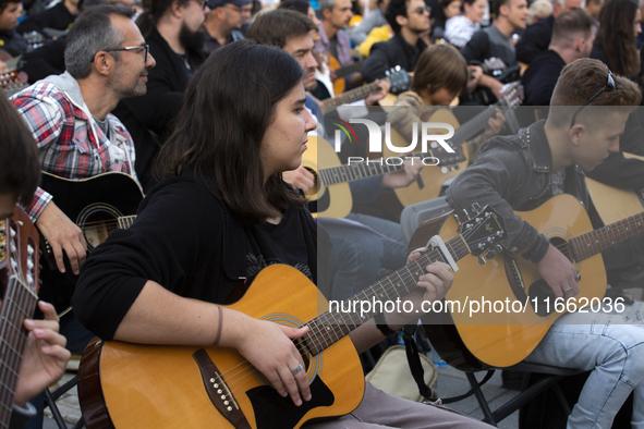 Guitar players simultaneously play the song ''Oath'' in Sofia, Bulgaria, on October 13, 2024, in memory of the legendary rock musician Kiril...