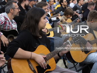 Guitar players simultaneously play the song ''Oath'' in Sofia, Bulgaria, on October 13, 2024, in memory of the legendary rock musician Kiril...