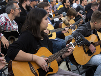 Guitar players simultaneously play the song ''Oath'' in Sofia, Bulgaria, on October 13, 2024, in memory of the legendary rock musician Kiril...