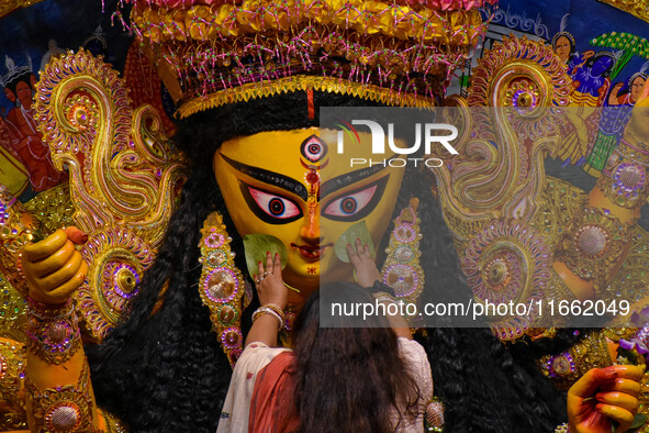 Married women offer their final prayer to Goddess Durga by presenting vermillion and sweets before the immersion of Durga idols on the last...