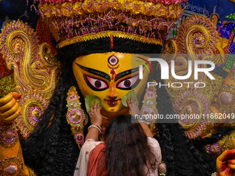 Married women offer their final prayer to Goddess Durga by presenting vermillion and sweets before the immersion of Durga idols on the last...