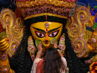 Married women offer their final prayer to Goddess Durga by presenting vermillion and sweets before the immersion of Durga idols on the last...