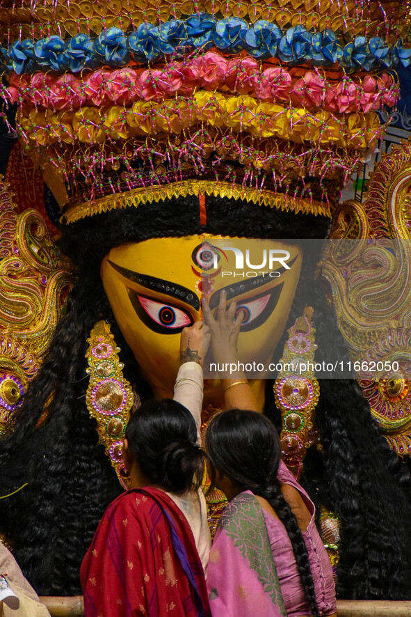 Married women offer their final prayer to Goddess Durga by presenting vermillion and sweets before the immersion of Durga idols on the last...