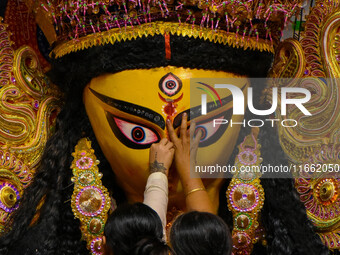 Married women offer their final prayer to Goddess Durga by presenting vermillion and sweets before the immersion of Durga idols on the last...