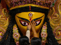 Married women offer their final prayer to Goddess Durga by presenting vermillion and sweets before the immersion of Durga idols on the last...