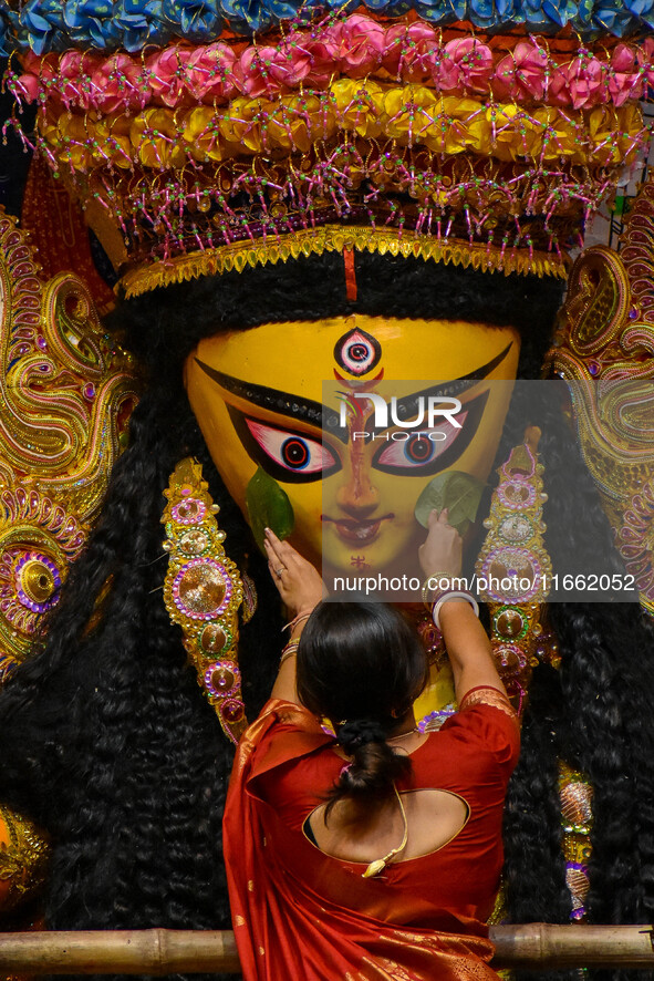 Married women offer their final prayer to Goddess Durga by presenting vermillion and sweets before the immersion of Durga idols on the last...