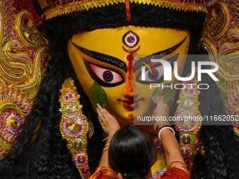 Married women offer their final prayer to Goddess Durga by presenting vermillion and sweets before the immersion of Durga idols on the last...