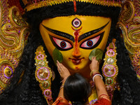 Married women offer their final prayer to Goddess Durga by presenting vermillion and sweets before the immersion of Durga idols on the last...