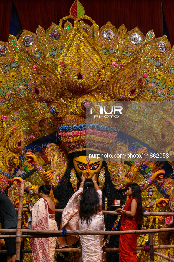 Married women offer their final prayer to Goddess Durga by presenting vermillion and sweets before the immersion of Durga idols on the last...