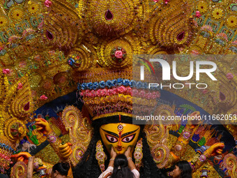 Married women offer their final prayer to Goddess Durga by presenting vermillion and sweets before the immersion of Durga idols on the last...