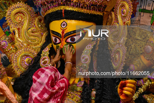 Married women offer their final prayer to Goddess Durga by presenting vermillion and sweets before the immersion of Durga idols on the last...