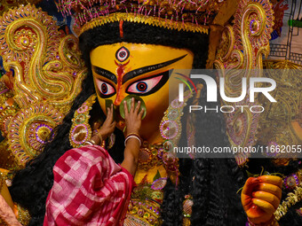 Married women offer their final prayer to Goddess Durga by presenting vermillion and sweets before the immersion of Durga idols on the last...