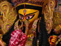 Married women offer their final prayer to Goddess Durga by presenting vermillion and sweets before the immersion of Durga idols on the last...