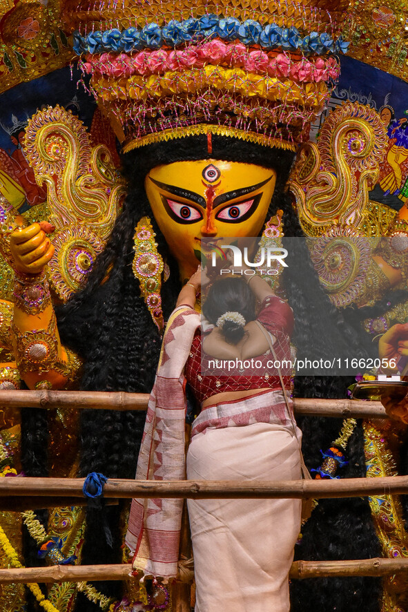 Married women offer their final prayer to Goddess Durga by presenting vermillion and sweets before the immersion of Durga idols on the last...