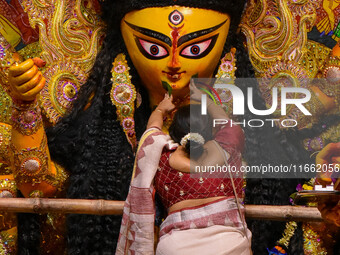 Married women offer their final prayer to Goddess Durga by presenting vermillion and sweets before the immersion of Durga idols on the last...