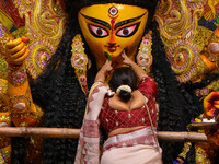 Married women offer their final prayer to Goddess Durga by presenting vermillion and sweets before the immersion of Durga idols on the last...