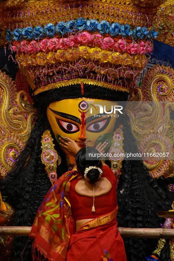 Married women offer their final prayer to Goddess Durga by presenting vermillion and sweets before the immersion of Durga idols on the last...