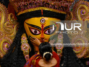 Married women offer their final prayer to Goddess Durga by presenting vermillion and sweets before the immersion of Durga idols on the last...