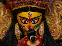 Married women offer their final prayer to Goddess Durga by presenting vermillion and sweets before the immersion of Durga idols on the last...