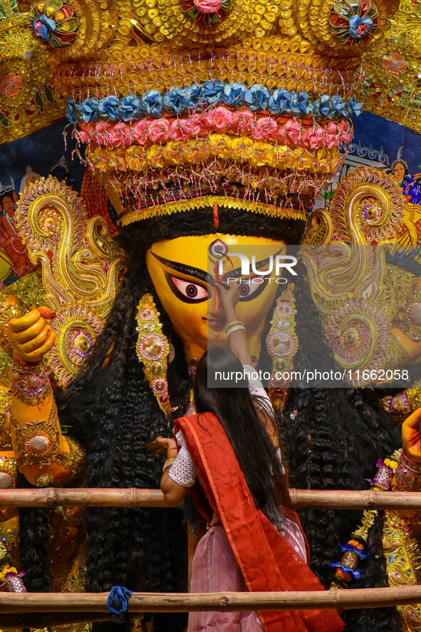 Married women offer their final prayer to Goddess Durga by presenting vermillion and sweets before the immersion of Durga idols on the last...