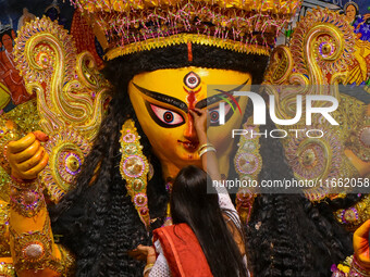 Married women offer their final prayer to Goddess Durga by presenting vermillion and sweets before the immersion of Durga idols on the last...