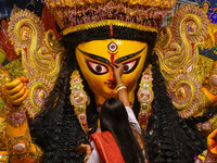 Married women offer their final prayer to Goddess Durga by presenting vermillion and sweets before the immersion of Durga idols on the last...