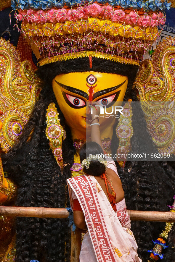 Married women offer their final prayer to Goddess Durga by presenting vermillion and sweets before the immersion of Durga idols on the last...