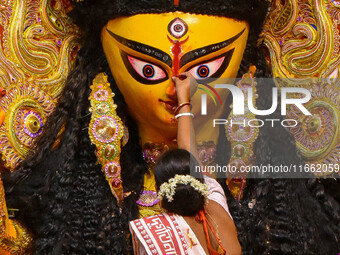 Married women offer their final prayer to Goddess Durga by presenting vermillion and sweets before the immersion of Durga idols on the last...